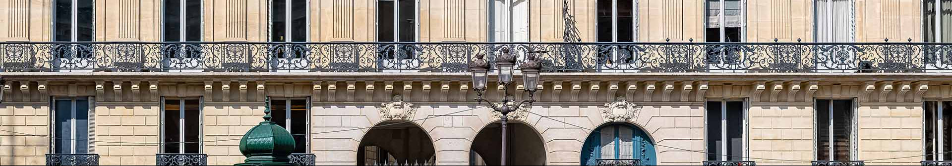 Stately building facade with decorative elements against a clear blue sky